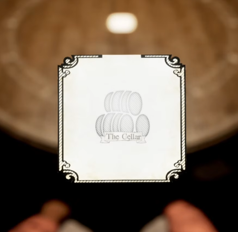 The Cellar room card held in first-person view