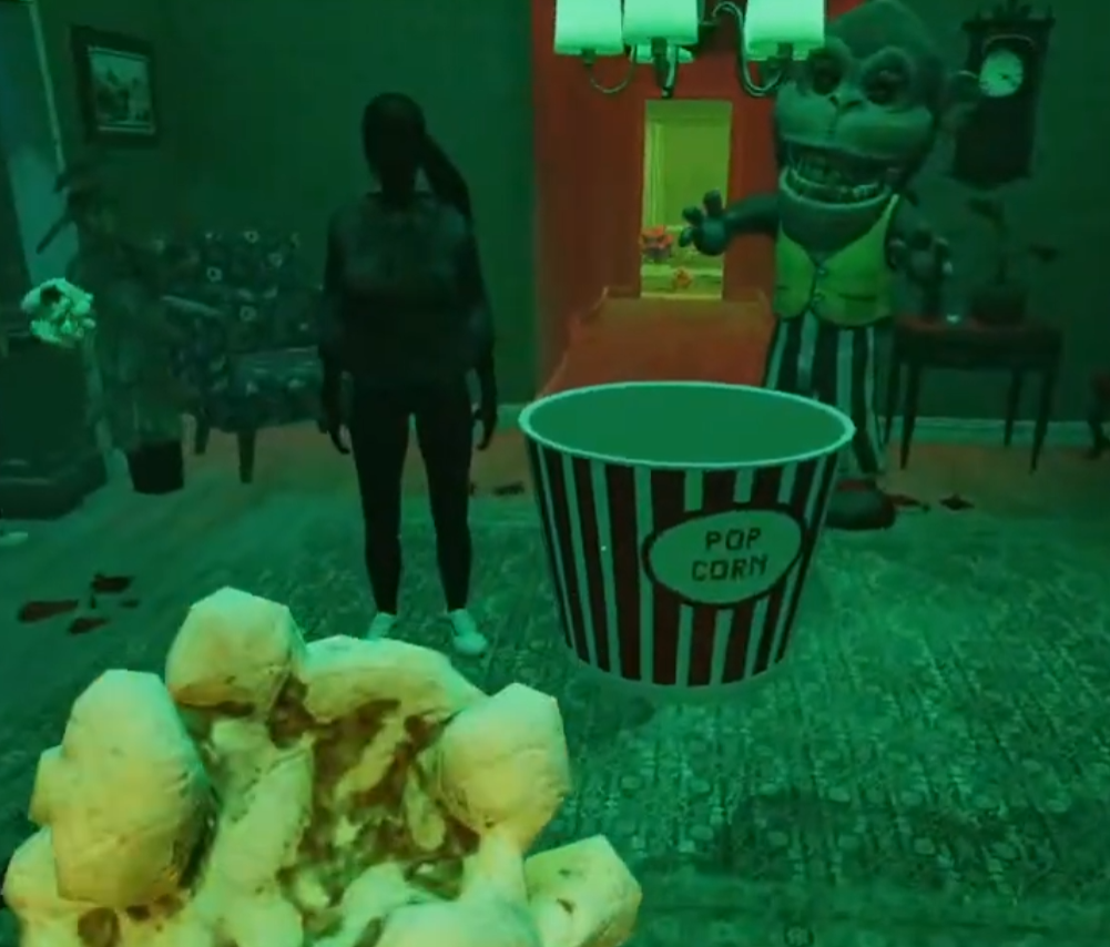 A player holding popcorn in front of the striped popcorn bucket with the giant monkey behind it